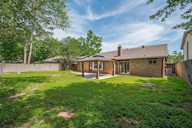 7011 Maple Fox Dr, Humble, TX 77338 - rear view of property featuring a patio, brick siding, a chimney, central AC, and a gazebo