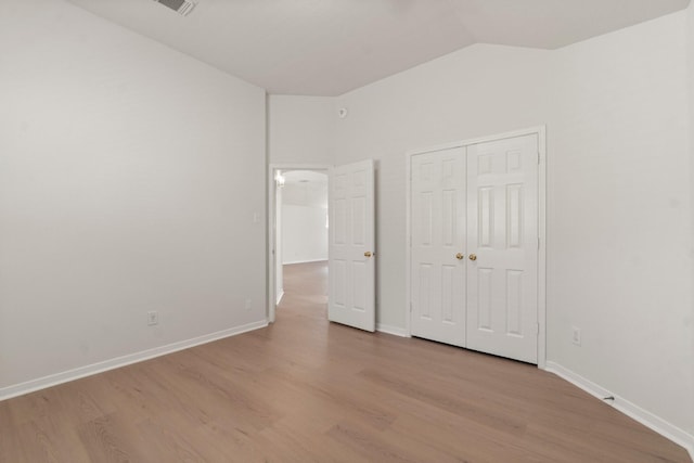 19827 Lajuana Ln, Spring, TX 77388 - unfurnished bedroom featuring lofted ceiling, wood finished floors, baseboards, and a closet