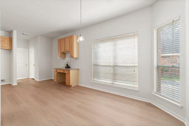 19827 Lajuana Ln, Spring, TX 77388 - kitchen with light brown cabinetry, light wood-type flooring, baseboards, and plenty of natural light