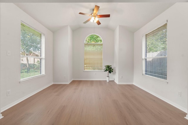 19827 Lajuana Ln, Spring, TX 77388 - empty room with light wood finished floors, vaulted ceiling, a ceiling fan, and baseboards