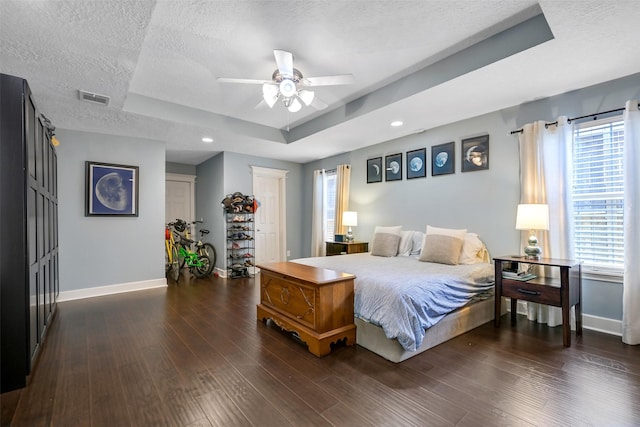 1731 W 22nd St, Houston, TX 77008 - bedroom with a raised ceiling, baseboards, a textured ceiling, multiple windows, and recessed lighting