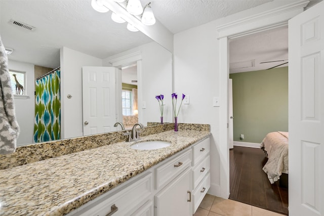 1731 W 22nd St, Houston, TX 77008 - full bath with vanity, a textured ceiling, tile patterned floors, baseboards, and a shower with shower curtain