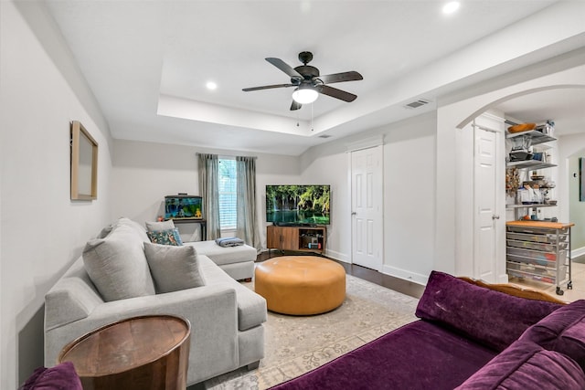 1731 W 22nd St, Houston, TX 77008 - living room featuring arched walkways, ceiling fan, recessed lighting, a raised ceiling, and baseboards