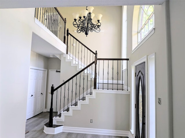 10067 Lazy Meadows Dr, Houston, TX 77064 - entryway with a towering ceiling, stairs, a chandelier, wood finished floors, and baseboards
