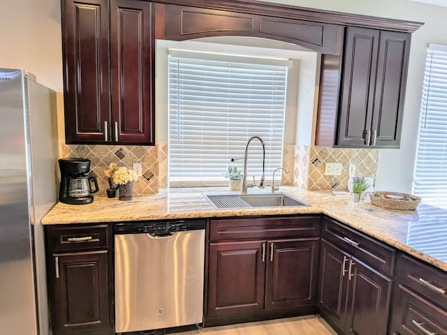 10067 Lazy Meadows Dr, Houston, TX 77064 - kitchen with stainless steel appliances, a sink, backsplash, and light stone counters