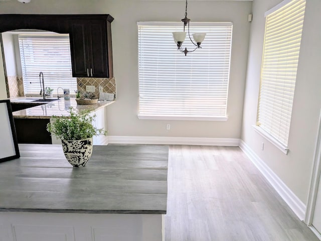 10067 Lazy Meadows Dr, Houston, TX 77064 - dining area with light wood-type flooring, baseboards, and arched walkways