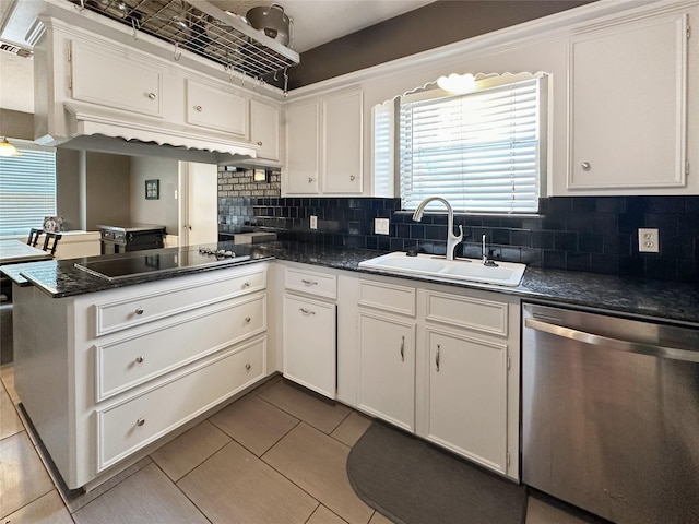 17407 Majestic Forest Dr, Spring, TX 77379 - kitchen featuring dishwasher, black electric cooktop, a sink, dark countertops, and a peninsula