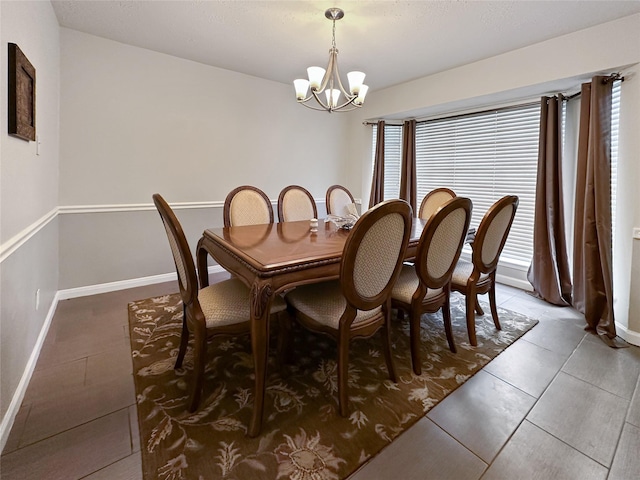 17407 Majestic Forest Dr, Spring, TX 77379 - dining area with a chandelier, light tile patterned floors, and baseboards