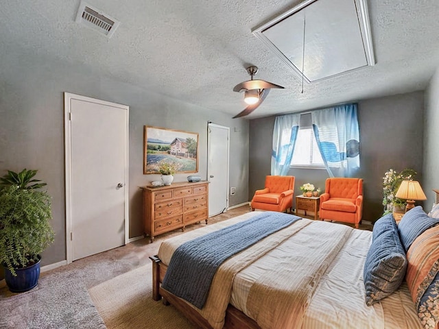 17407 Majestic Forest Dr, Spring, TX 77379 - bedroom with attic access, a textured ceiling, light carpet, and a ceiling fan