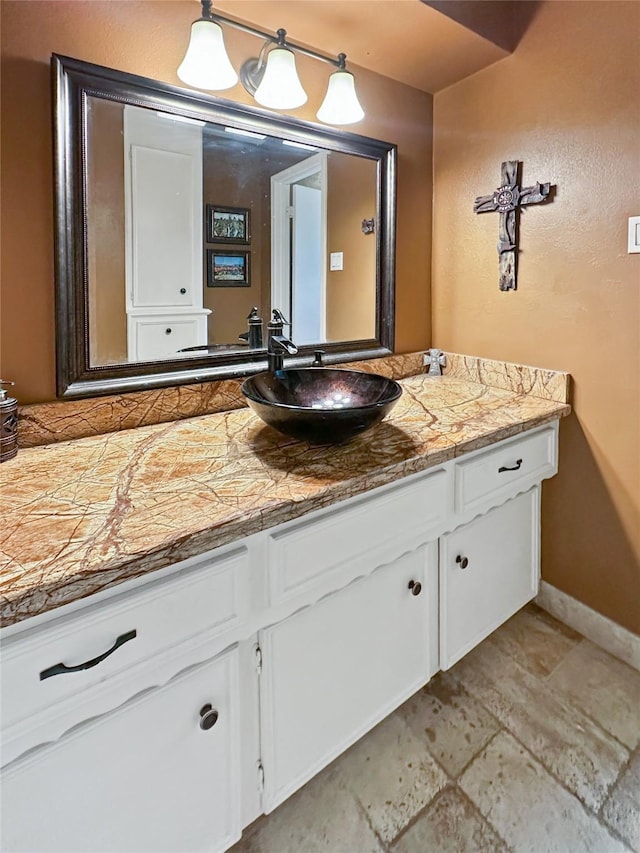 17407 Majestic Forest Dr, Spring, TX 77379 - bathroom featuring stone finish flooring, vanity, and baseboards
