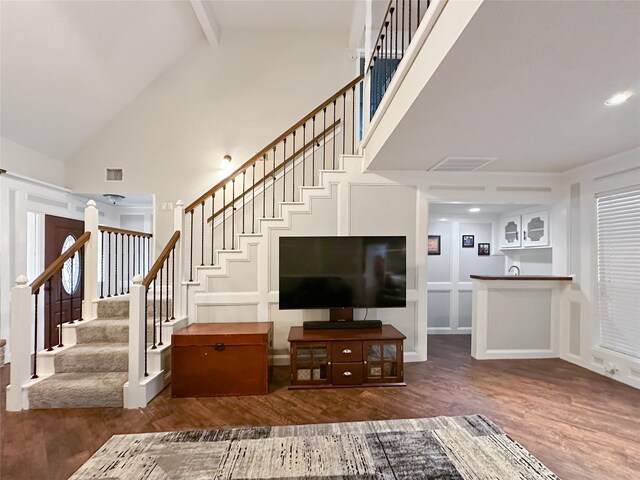 17407 Majestic Forest Dr, Spring, TX 77379 - living area featuring wood finished floors, stairway, beam ceiling, high vaulted ceiling, and recessed lighting