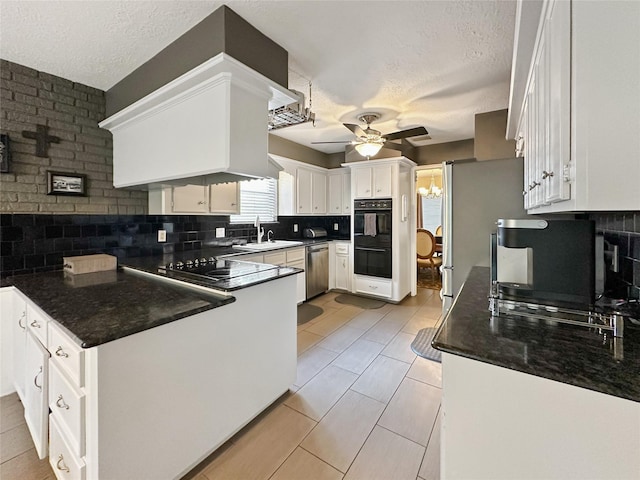 17407 Majestic Forest Dr, Spring, TX 77379 - kitchen with black appliances, ceiling fan, a sink, tasteful backsplash, and a textured ceiling