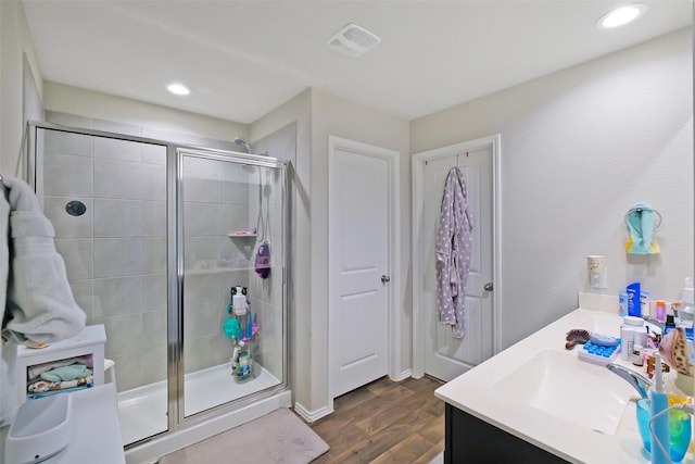 8434 Violet Hills Ln, Rosharon, TX 77583 - bathroom with a stall shower, wood finished floors, vanity, and recessed lighting