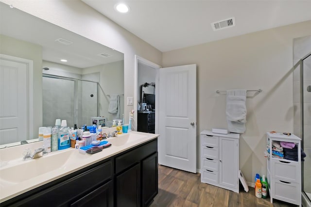 8434 Violet Hills Ln, Rosharon, TX 77583 - full bathroom featuring a stall shower, double vanity, wood finished floors, and recessed lighting