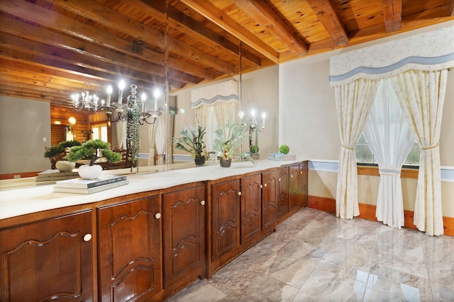 1000 W Polk St, Livingston, TX 77351 - full bath with wooden ceiling with exposed beams, a chandelier, plenty of natural light, double vanity, and baseboards