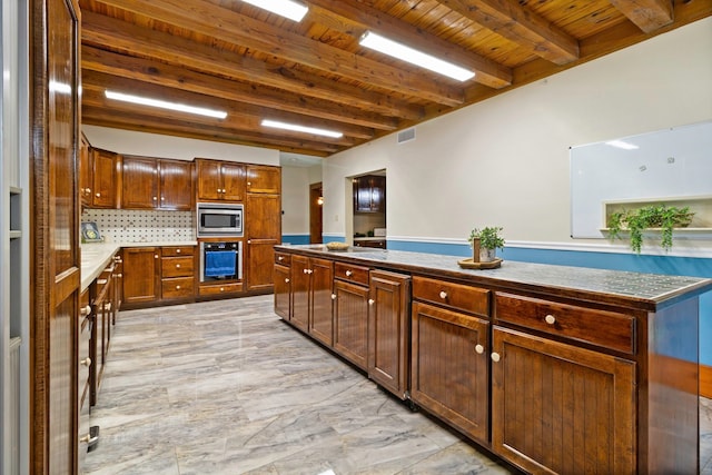 1000 W Polk St, Livingston, TX 77351 - kitchen featuring stainless steel appliances, wooden ceiling with exposed beams, light marble finish floors, and decorative backsplash
