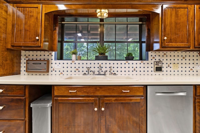 1000 W Polk St, Livingston, TX 77351 - kitchen with dishwasher, a sink, light countertops, and brown cabinets
