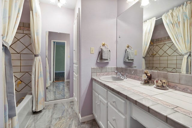 1000 W Polk St, Livingston, TX 77351 - bathroom with vanity, marble finish floors, shower / bath combo with shower curtain, and baseboards
