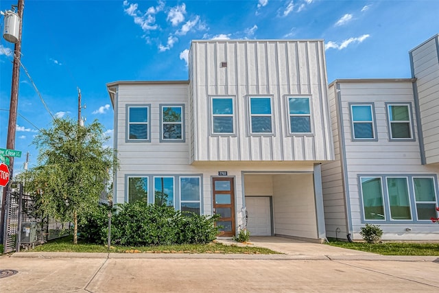 7703 Rainbow Close Ln, Houston, TX 77055 - multi unit property featuring an attached garage, concrete driveway, board and batten siding, and fence