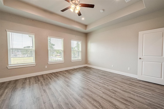 7703 Rainbow Close Ln, Houston, TX 77055 - empty room with a raised ceiling, wood finished floors, a ceiling fan, baseboards, and a smoke detector