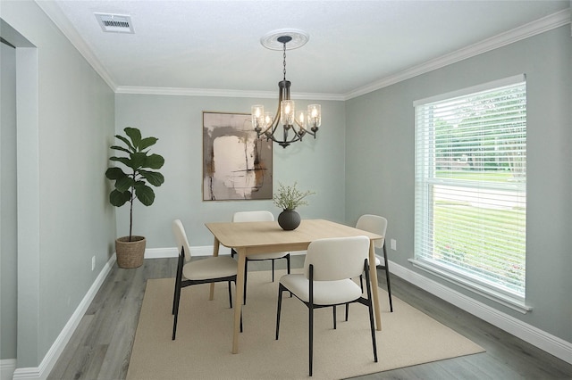 15202 Delbarton Dr, Houston, TX 77083 - dining space with light wood finished floors, a chandelier, ornamental molding, and baseboards