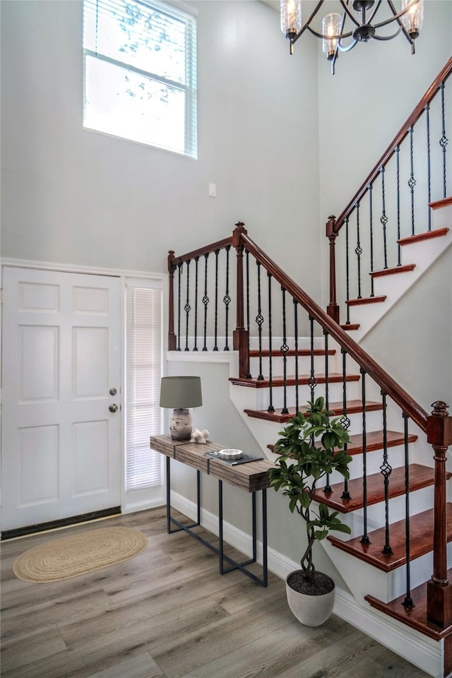 15202 Delbarton Dr, Houston, TX 77083 - entrance foyer with wood finished floors, a chandelier, stairs, and a high ceiling
