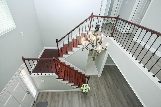 15202 Delbarton Dr, Houston, TX 77083 - staircase with wood finished floors, a chandelier, and baseboards