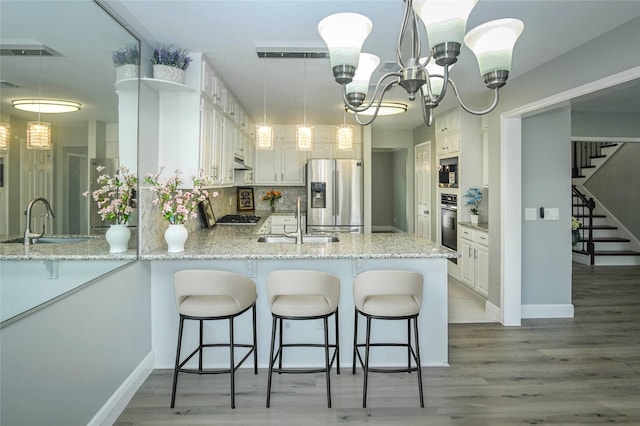 15202 Delbarton Dr, Houston, TX 77083 - kitchen with stainless steel appliances, a sink, and light wood finished floors