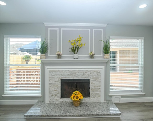 15202 Delbarton Dr, Houston, TX 77083 - detailed view of wood finished floors, recessed lighting, baseboards, and a stone fireplace