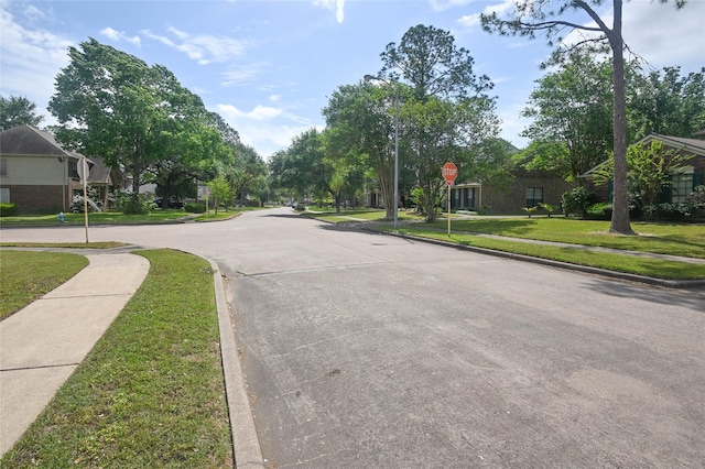 15202 Delbarton Dr, Houston, TX 77083 - view of road featuring traffic signs, sidewalks, and curbs