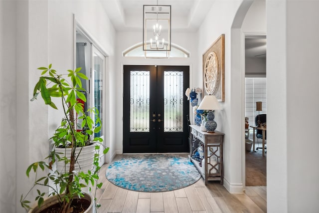 3607 Brook St, Rosharon, TX 77583 - entrance foyer with french doors, arched walkways, wood finished floors, a raised ceiling, and baseboards