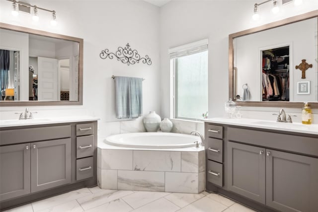 3607 Brook St, Rosharon, TX 77583 - bathroom with marble look tiles, a garden tub, two vanities, and a spacious closet