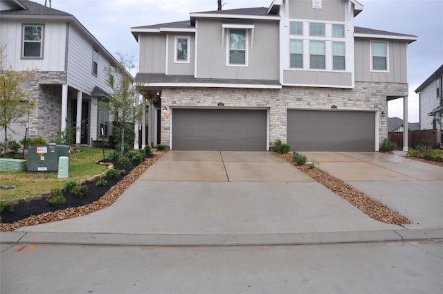 673 Royal Arch Dr, Conroe, TX 77304 - view of front of home featuring stone siding, driveway, an attached garage, and board and batten siding