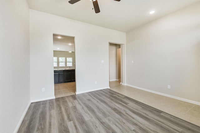 12638 Silver Winter Trl, Houston, TX 77014 - empty room featuring ceiling fan, light wood-style floors, recessed lighting, and baseboards