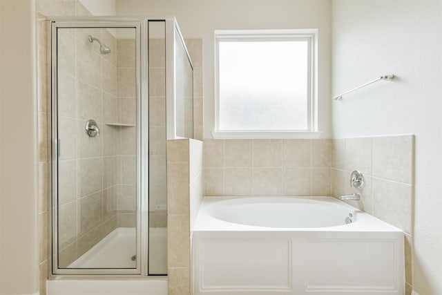 12638 Silver Winter Trl, Houston, TX 77014 - full bathroom featuring a bath and a stall shower