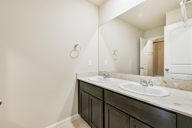 12638 Silver Winter Trl, Houston, TX 77014 - bathroom featuring double vanity, tile patterned flooring, baseboards, and a shower