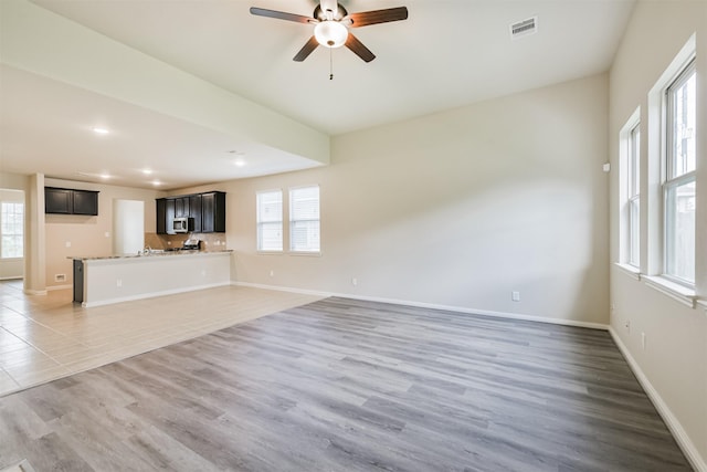 12638 Silver Winter Trl, Houston, TX 77014 - unfurnished living room featuring ceiling fan, baseboards, recessed lighting, and light wood-style flooring