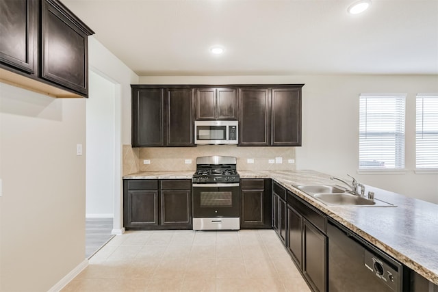 12638 Silver Winter Trl, Houston, TX 77014 - kitchen featuring stainless steel appliances, a sink, tasteful backsplash, dark brown cabinets, and light countertops