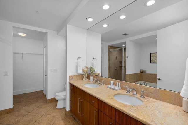 310 Padre Blvd Unit 2305, South Padre Island, TX 78597 - bathroom featuring a stall shower, a spacious closet, double vanity, toilet, and recessed lighting