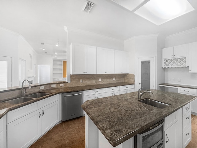 2424 Katy Hockley Cut Off Rd, Katy, TX 77493 - kitchen featuring a sink, dishwasher, dark stone counters, white cabinetry, and crown molding