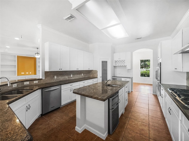 2424 Katy Hockley Cut Off Rd, Katy, TX 77493 - kitchen featuring appliances with stainless steel finishes, a sink, tasteful backsplash, dark stone counters, and crown molding