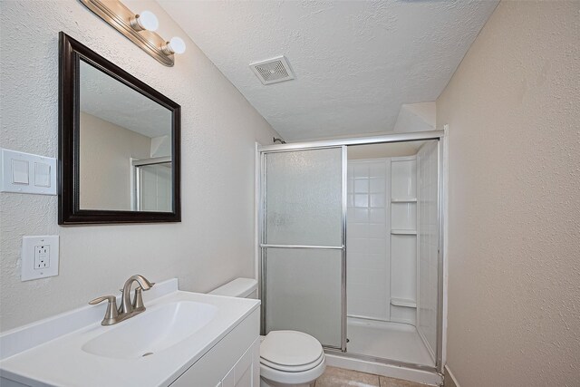2409 Spears Dr, Humble, TX 77396 - full bath with toilet, a shower stall, a textured ceiling, vanity, and a textured wall