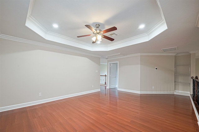 2409 Spears Dr, Humble, TX 77396 - unfurnished living room with a tray ceiling, a ceiling fan, crown molding, wood finished floors, and baseboards