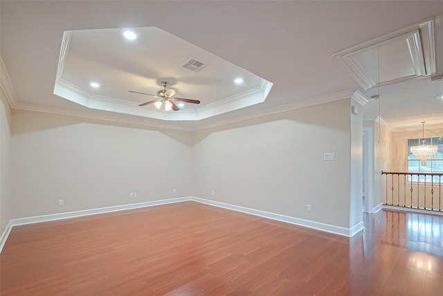 2409 Spears Dr, Humble, TX 77396 - unfurnished room with attic access, ornamental molding, light wood-type flooring, a ceiling fan, and a tray ceiling