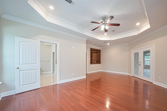 2409 Spears Dr, Humble, TX 77396 - spare room featuring a raised ceiling, a ceiling fan, wood finished floors, ornamental molding, and baseboards