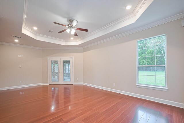 2409 Spears Dr, Humble, TX 77396 - spare room featuring a raised ceiling, a ceiling fan, wood finished floors, ornamental molding, and french doors