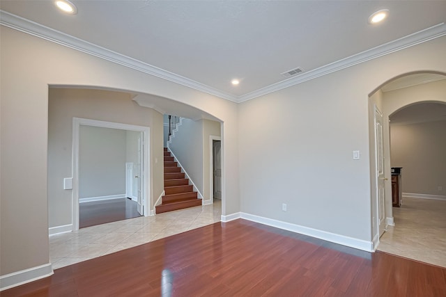 2409 Spears Dr, Humble, TX 77396 - unfurnished room with wood finished floors, crown molding, stairway, arched walkways, and recessed lighting