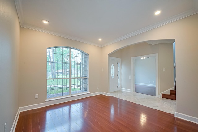 2409 Spears Dr, Humble, TX 77396 - unfurnished room with wood finished floors, arched walkways, ornamental molding, stairway, and baseboards