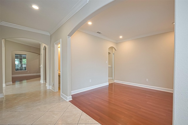 2409 Spears Dr, Humble, TX 77396 - spare room with ornamental molding, arched walkways, recessed lighting, light tile patterned flooring, and baseboards