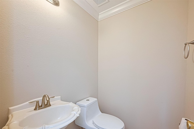 2409 Spears Dr, Humble, TX 77396 - bathroom featuring a sink, toilet, and ornamental molding